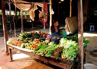 Young woman  selling produce at village market near Siem Reap
