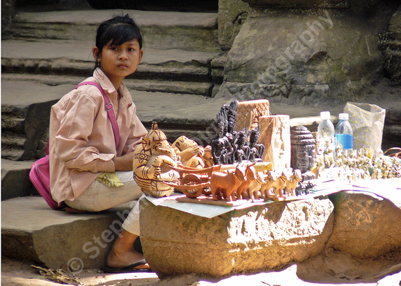 Girl selling souvenirs at Ta Prom Temple