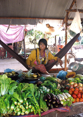 Young woman selling produce at village market near Siem Reap