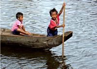 Two boys on boat  in floating village